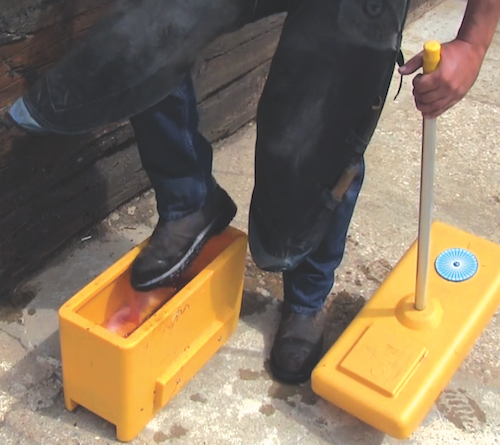 farrier disinfects shoes in stable