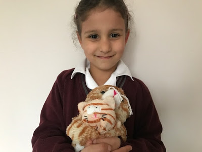 Child holding cuddly toys