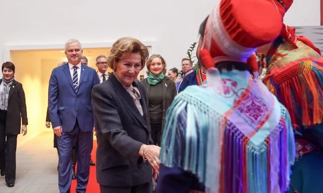 Queen Sonja wore a white peplum jacket and white cashmere cape. Queen wore a brown blazer suit
