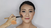 Modern Oriental Bridal Makeup -  Contour the face and nose area with bitten cocoa
