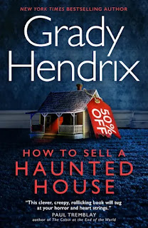 Book "How to Sell a Haunted House" by Grady Hendrix. A floor and a wall, covered in blue wallpaper and a blue carpet. Both have seen better days. Between them is white skirting board, and in front of that, a battered model house with a red label attached saying "50% off". Red light shines out of the front door onto the porch...