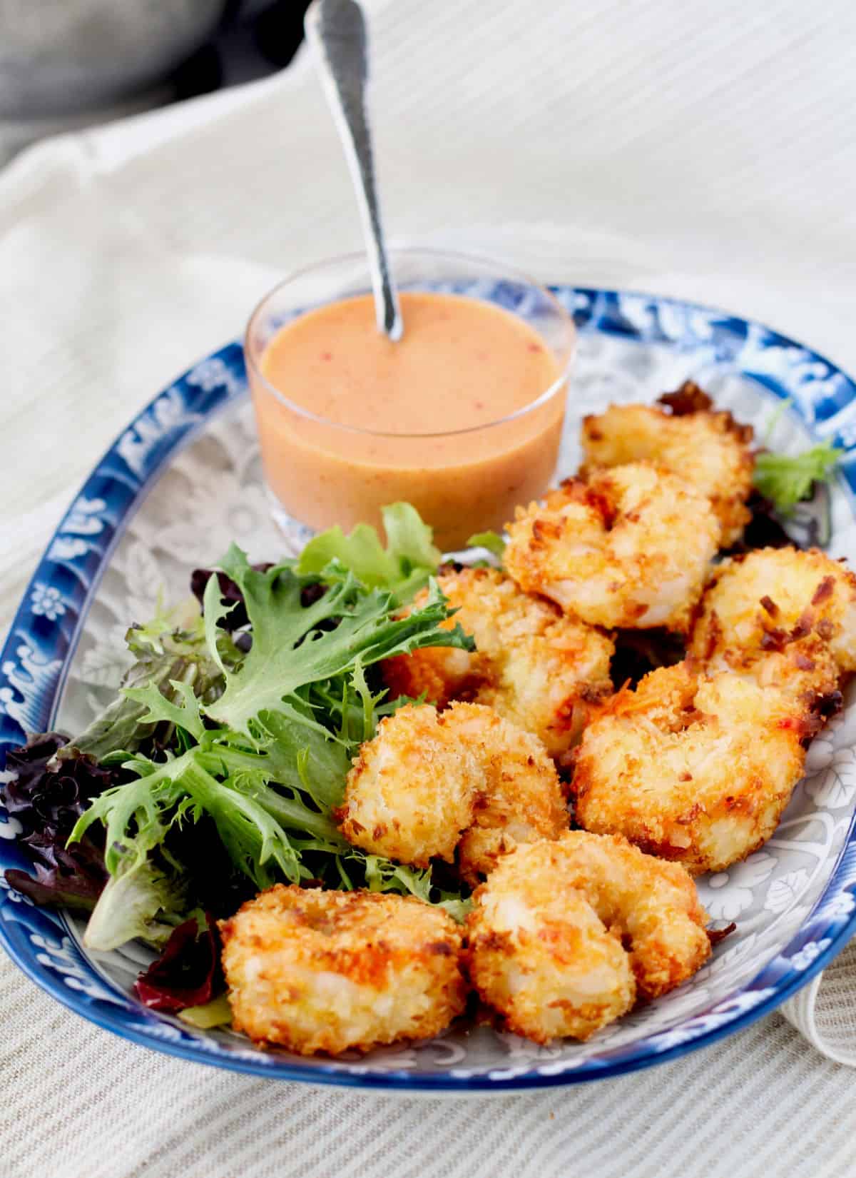 Air Fryer Crispy Coconut Shrimp with sauce in an oval Asian bowl.