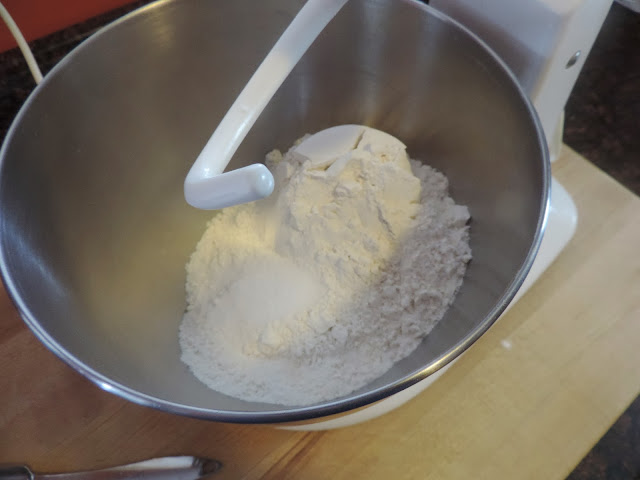 A picture of the mixer bowl with flour in it. 