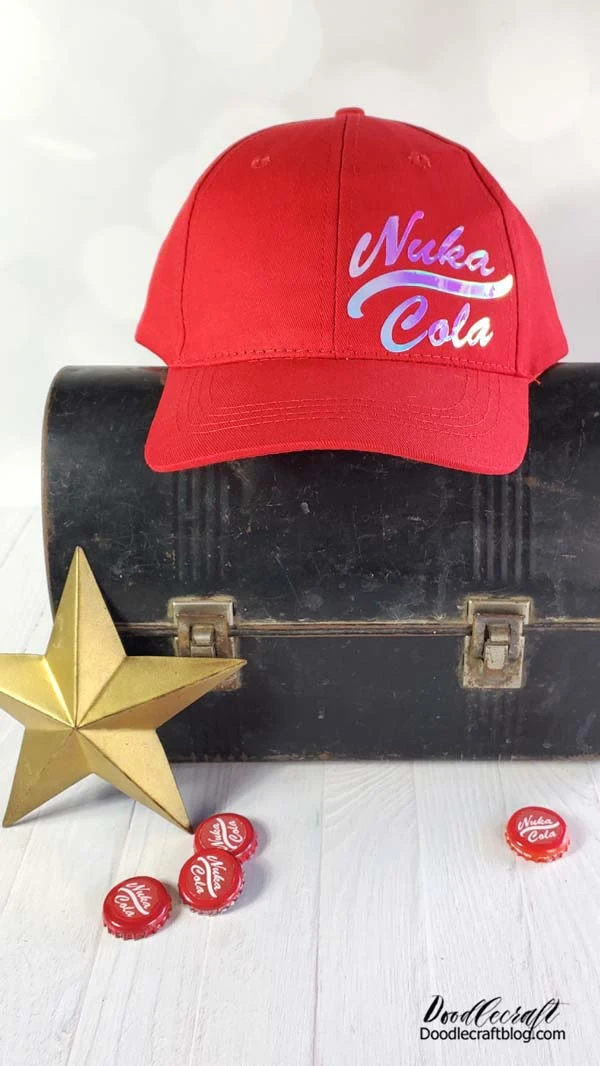 Nuka Cola baseball cap with iridescent logo sitting on top of a dusty mole miner pail near scattered caps and a gold metal star.