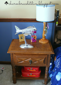 silver aluminum desk top airplane model on a bedside table