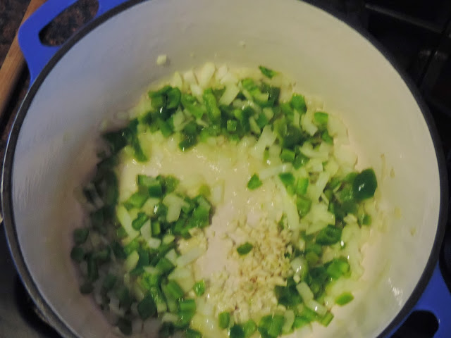 The onion, green pepper, and garlic sautéing in the pot. 