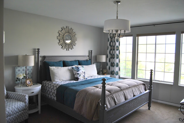 master bedroom, teal master bedroom, turquoise master bedroom, blue master bedroom, calm, designed, blogger, king size bed, sunburst mirror above bed, sunburst mirror, oval night stands, white night stands, gray bed, aloof gray, accent chair, 12 drawer dresser, malm dresser, white drum chandelier, drum chandelier, chandelier