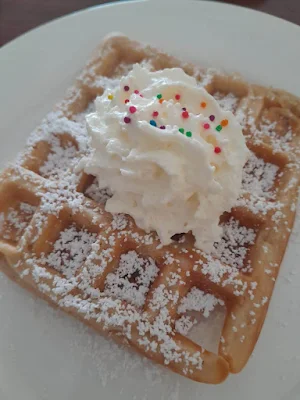 " Waffle with whipped cream and sprinkles from restaurant De verdieping in Paramaribo"