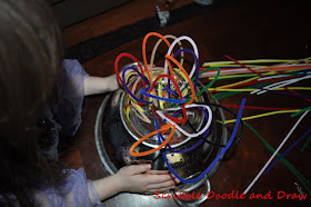 Build fine motor muscles by threading pipe cleaners into a collinder