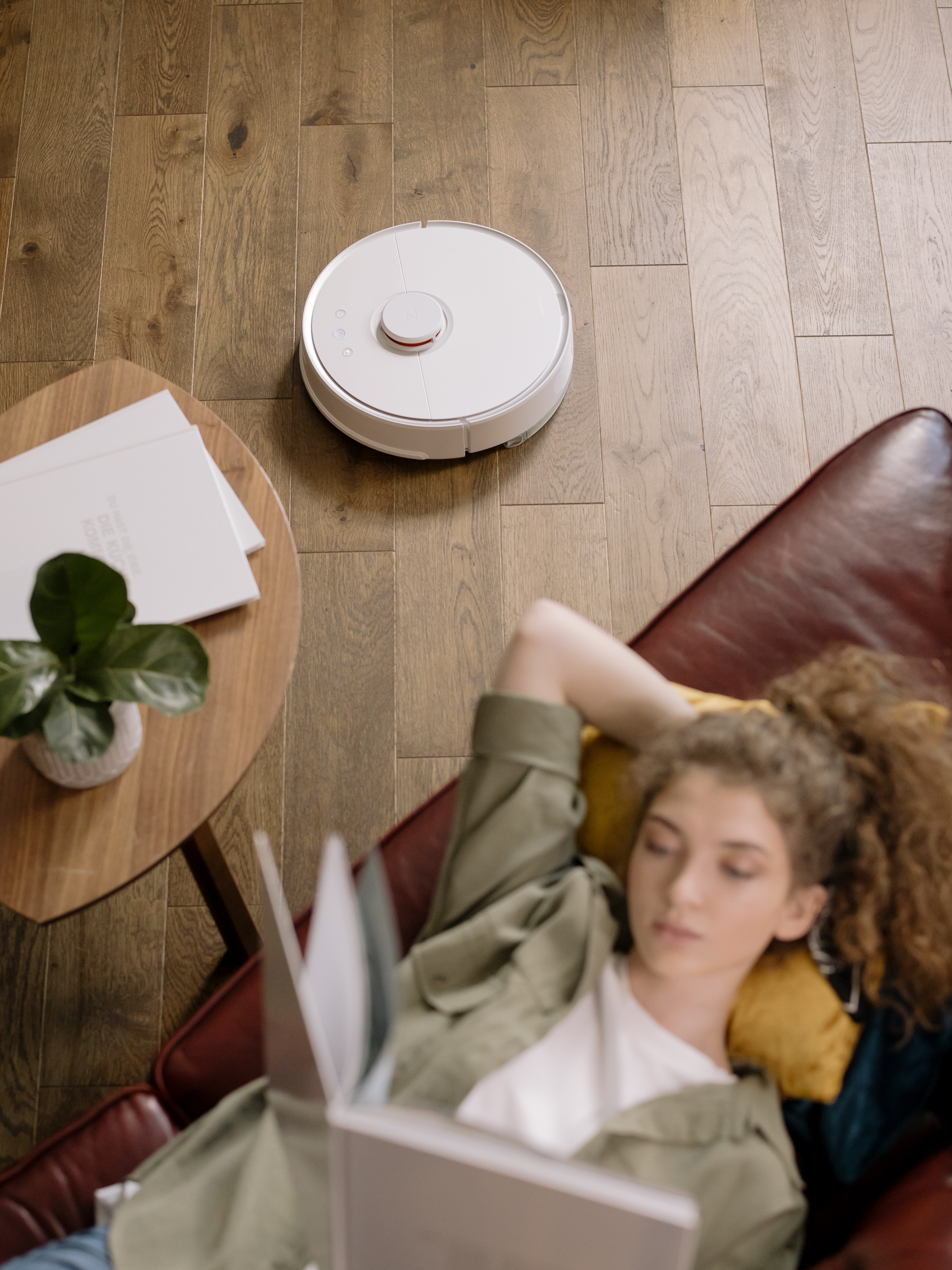 woman in white shirt lying on brown leather couch