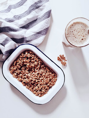 A bowl of cereal and a chocolate drink