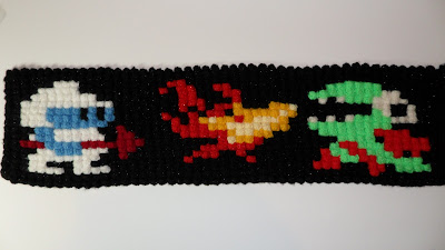 Pixel Art. Scarf with Dig Dug. Dig Dug. Dragon. Fire. Fygar breathing fire. By Artist The Oracle EJHamilton. E J Hamilton. Hamilton. Edinburgh. Scotland.