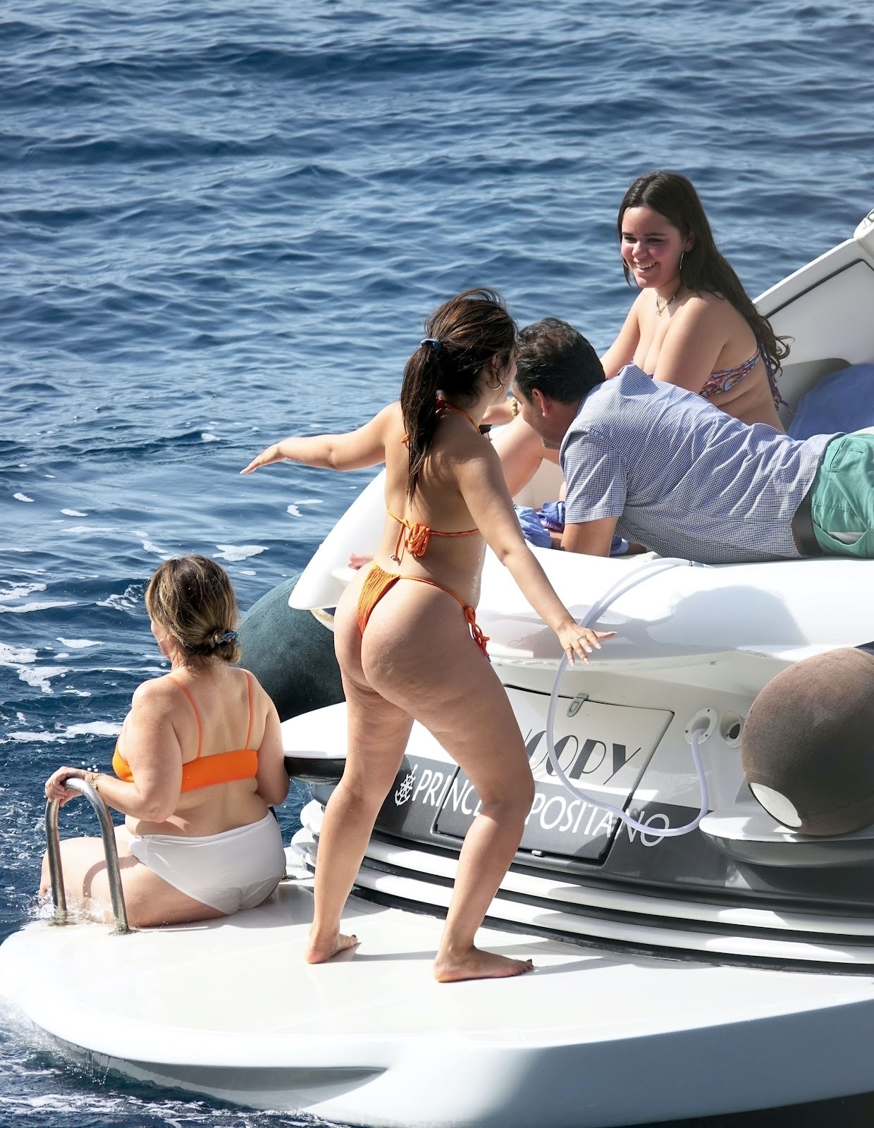 Camila Cabello in a orange bikini while enjoying a dip in the ocean off the coast of Capri in Italy.
