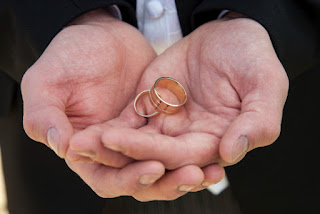 wedding rings in the hands of the best man