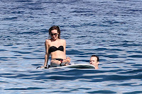 Olivia Wilde sitting on Paddle Board 