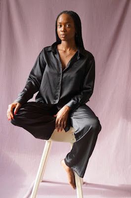 Headspace's Dora Kamau photo seated on a stool