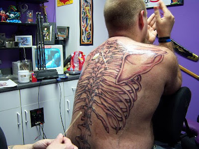 skeleton hand tattoo. star tattoos on back men. mens