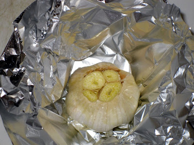 Preparing to roast whole garlic head