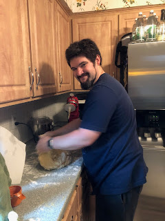 A picture of a white bearded man kneading dough at a kitchen counter (the man is me).