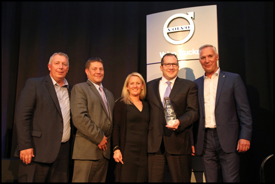 S&S Volvo dealer principal Todd Schaub (right of center) and wife Lynn Schaub (center) receive the award for the 2017 Volvo Trucks North American Dealer of the Year from (left to right) Bruce Kurtt, senior vice president of sales for Volvo Trucks North America, Chris Gossler, regional vice president northeast U.S. region and Göran Nyberg, president of Volvo Trucks North America