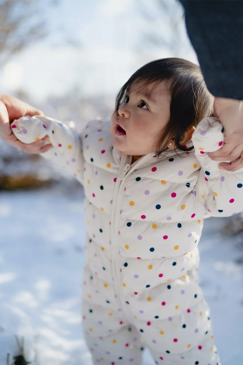 toddler in a feather coat