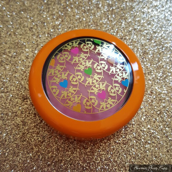 orange compact with patterned lid and pink blush inside