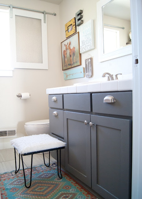 Project Kid's Bathroom Makeover - before & after - new tile, painted vanity, gallery wall, wood shelves and  antler organizers.