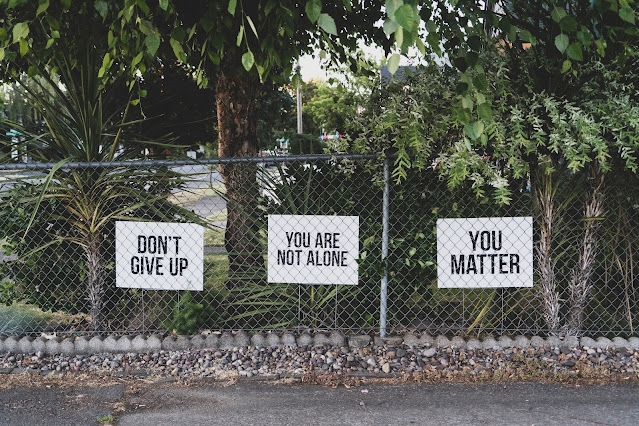 positive affirmation signs on chain fence:Photo by Dan Meyers on Unsplash