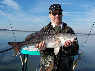 fisherman with redfish