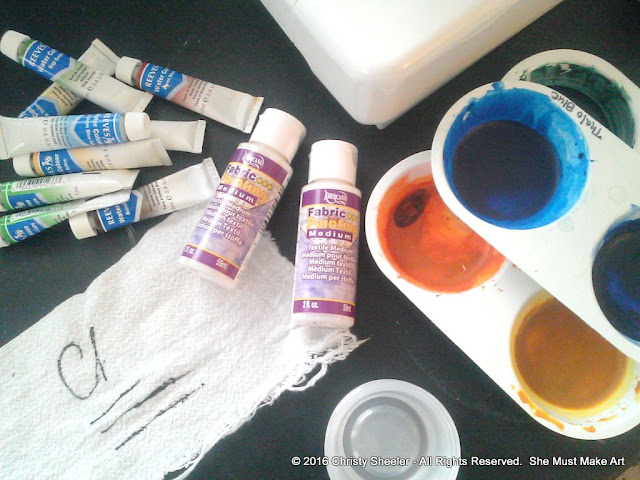 Gathering supplies for the practice run with watercolors on fabric.