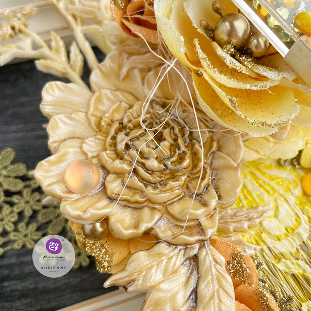 Altered paintbrush in yellow and gold, using Finnabair art mediums and Prima Marketing flowers.