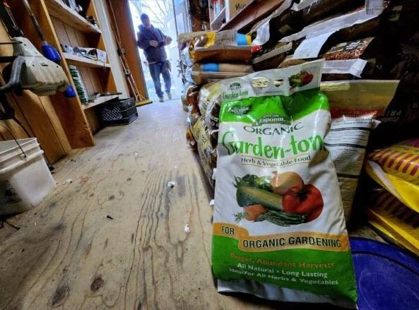 Fortitude Ranch Nevada manager Brandon M enters the work shed where gardening supplies are kept on March 2, 2023.