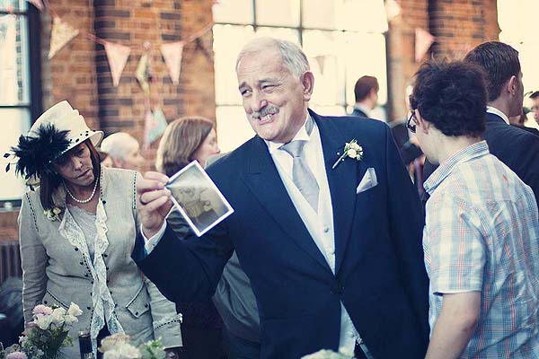 guests checking out photos at tables at St Chads place wedding