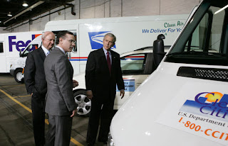 President George W. Bush and Secretary of Energy Sam Bodman listen to Mark Chernoby as the Vice President of Advance Vehicle Engineering at DaimlerChrysler describes the FedEx Pilot Program Plug-in Hybrid Sprinter during the President's visit Tuesday, March 27, 2007, to the U.S. Postal Service Vehicle Maintenance Facility in Washington, D.C. White House photo by Joyce Boghosian.