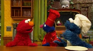 As Elmo, Cookie, and Grover sign off, Cookie scarfs down the last piece of cake. Sesame Street Episode 5002, The Great Sesame Street Cake-Off, Season 50