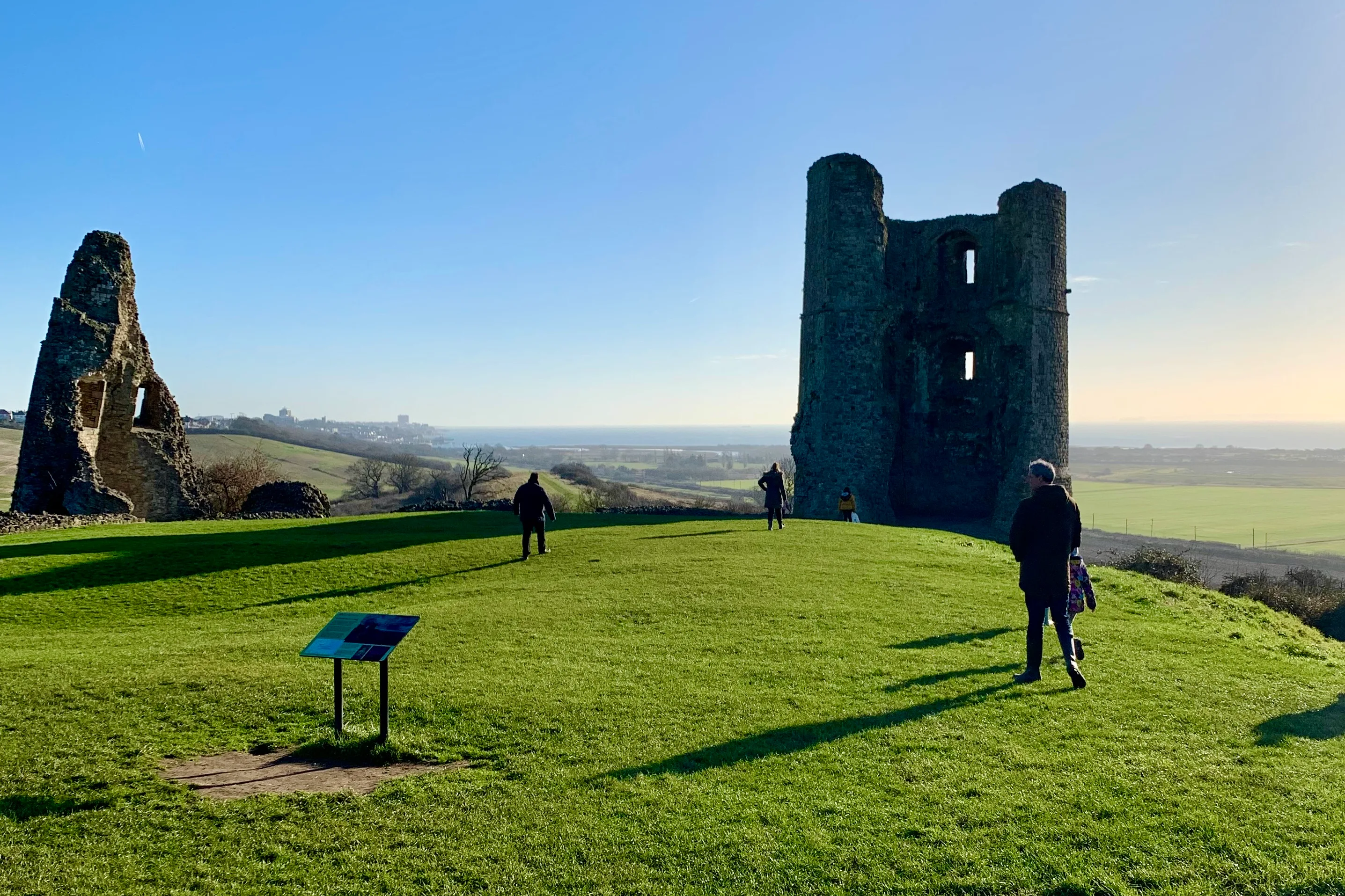 The ruins of Hadleigh Castle in Essex and an information board