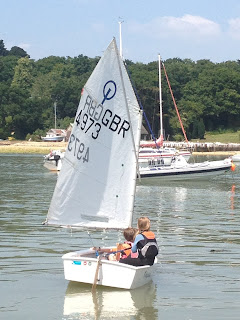 Haydn Sewell teaching his sister Freya Sewell to sail an Optimist