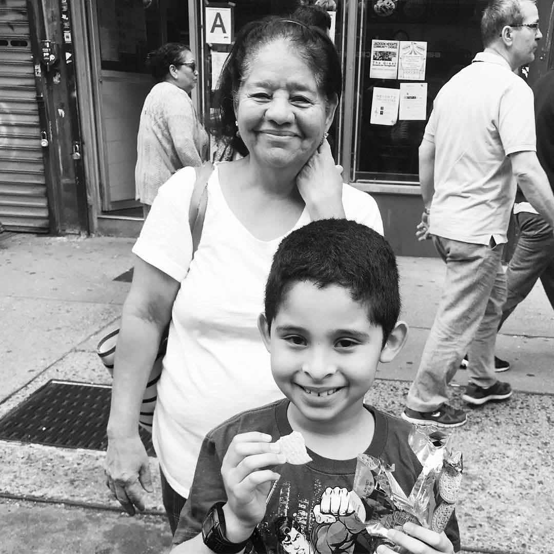 A mother and her son await the arrival of the Queens Pride parade in Jackson Heights.