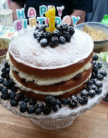 birthday cake, Victoria sponge, blueberries and blackberries & candles spelling happy birthday and 1
