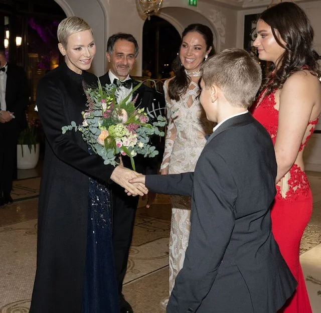 Princess Charlene wore a new sequined sleeveless tulle gown by Carolina Herrera. Christmas Ball 2022