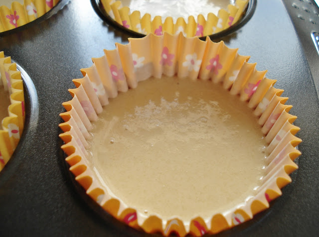 Spoon the cake mixture into the muffin cases until about half full.