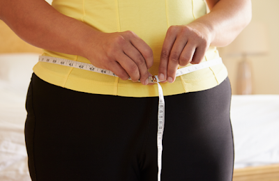 Female with tape measure around her waist