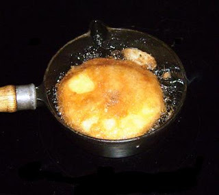 apple fritter frying in oil