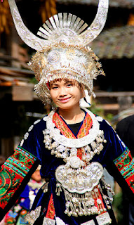 photo of a girl in traditional costume wearing a miao silver headdress