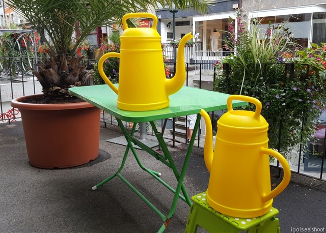 This looks like the gardening cans outside a shop along  Obere Hauptgasse are having a chat.