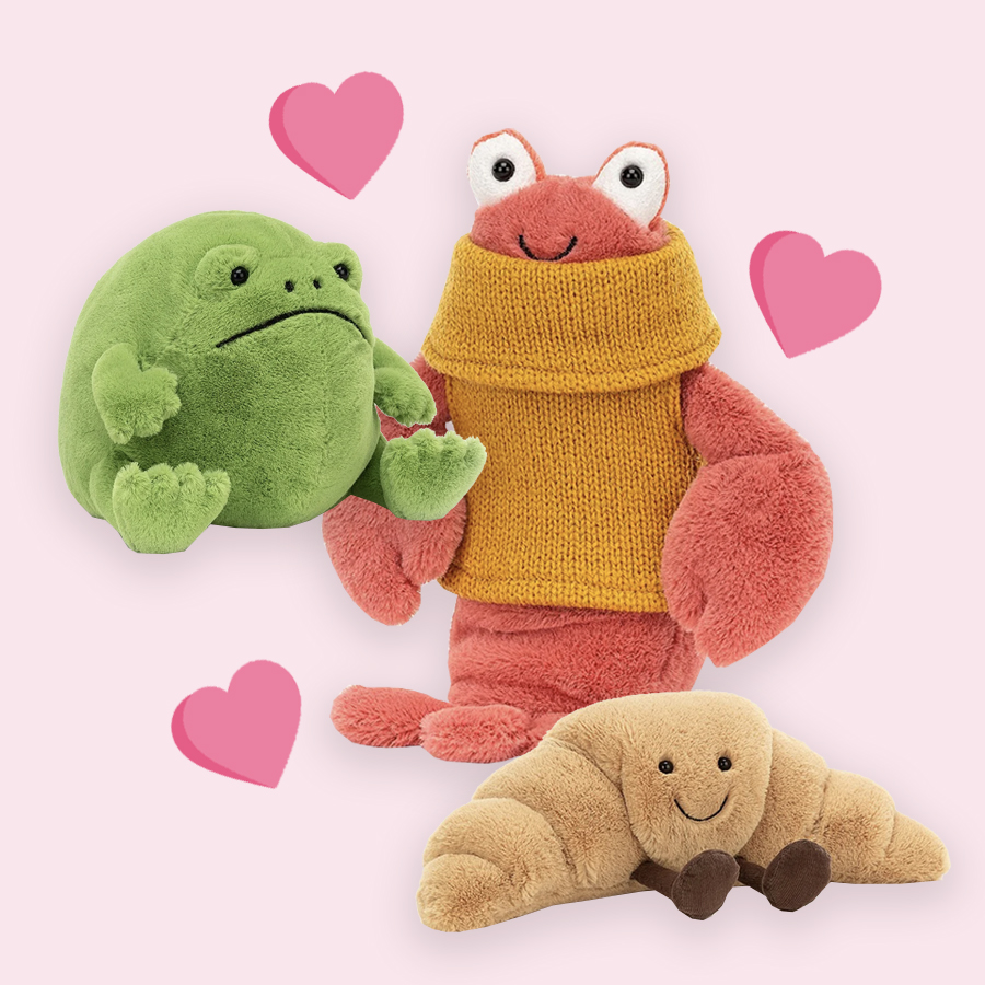 A lobster, croissant and frog plushies with hearts surrounding it.