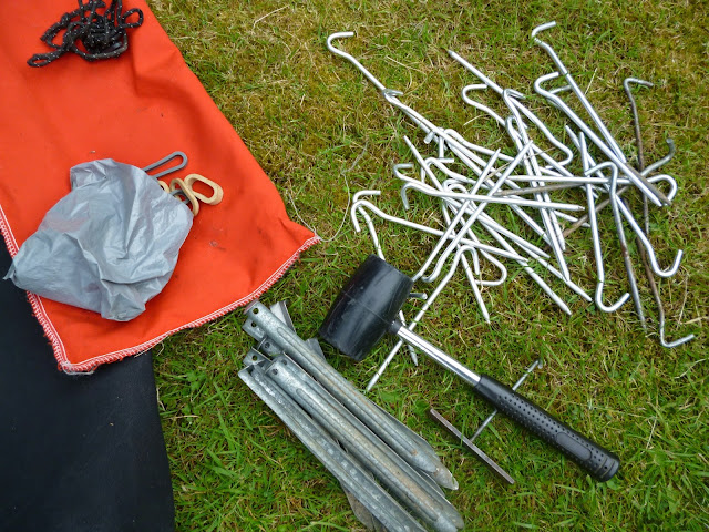 tent pegs and mallet on a lawn