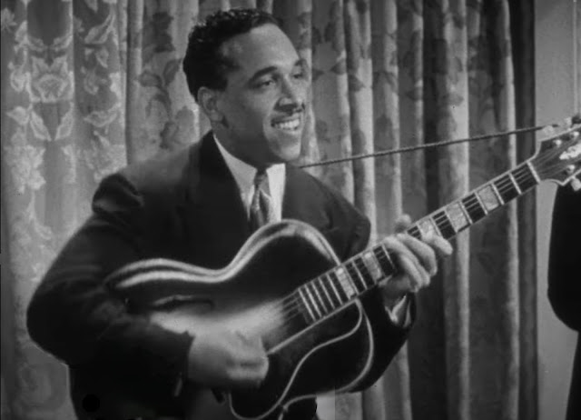 Oscar Moore plays his guitar in a soundie from 1944 of the King Cole Trio with Ida James