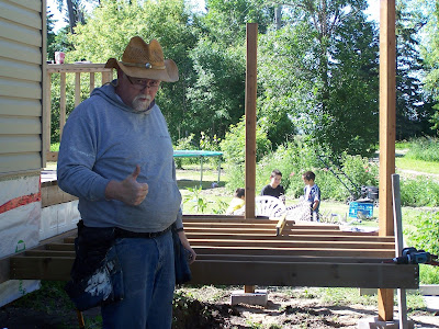 man giving thumbs up building gazebo