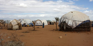 Refugee shelters in Somalia: The report says more migrants are likely. (Image Credit: DFID/UK Dept for International Development via Wikimedia Commons) Click to Enlarge.